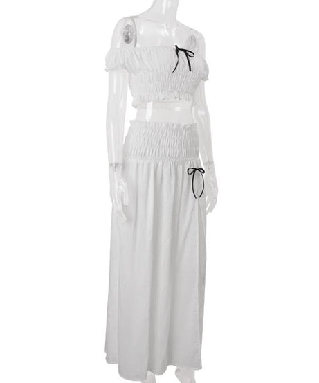 Effortless Resort Chic: White Smocked Off-Shoulder Crop Top & Slit Maxi Skirt Set with Bow Details | Your Winter Getaway Essential